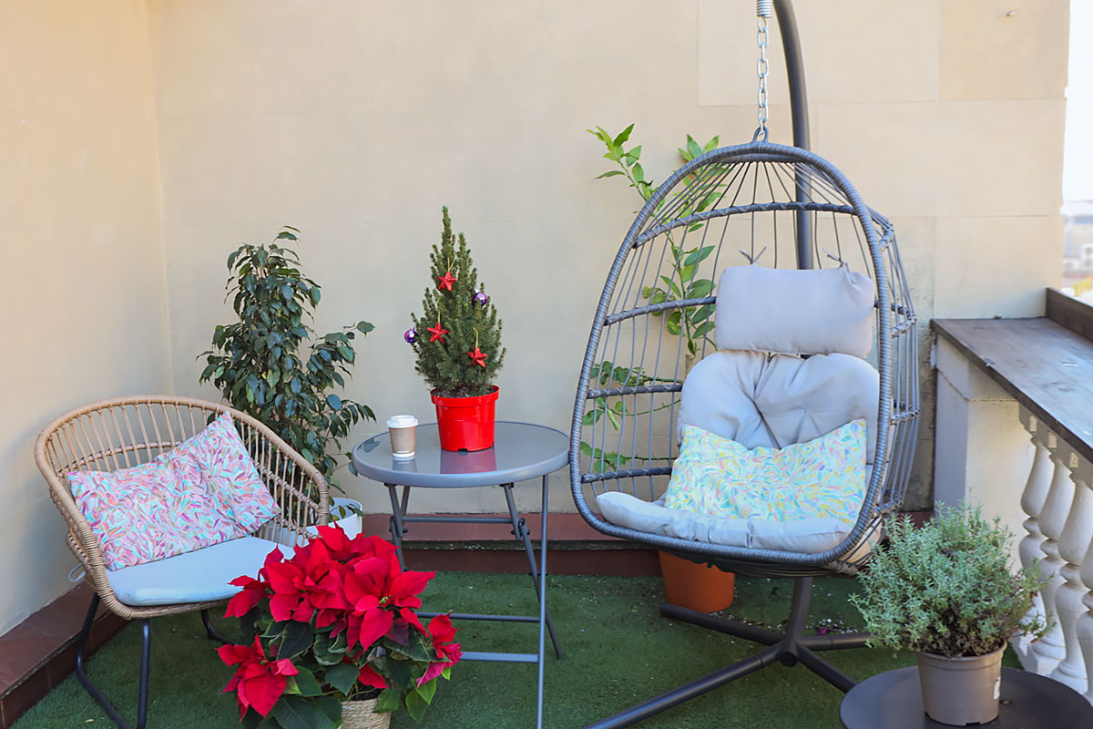 Terrace of Sunlight School in Barcelona with armchairs and a hanging chair for relaxation